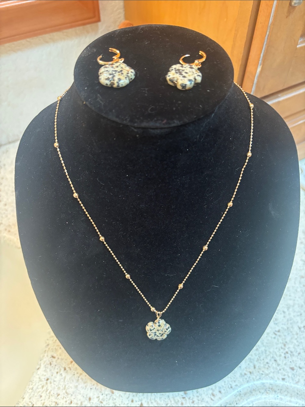 Gold-Tone Necklace with Speckled White Flower Pendant and matching earrings.